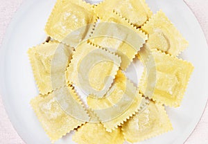 Uncooked ravioli on plate