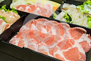 Uncooked raw fresh pork slices for Sukiyaki. Isolated on white b