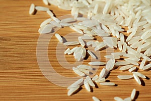 Uncooked raw rice background on wood texture