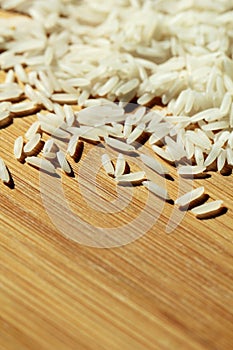 Uncooked raw rice background on wood texture