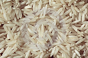Uncooked raw rice background on wood texture
