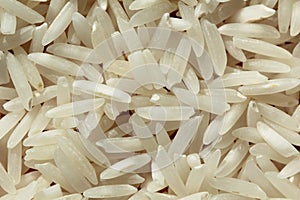 Uncooked raw rice background on wood texture