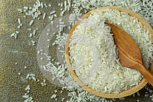 uncooked rice or dry rice. raw rice in wooden bowl with wooden spoon and fork