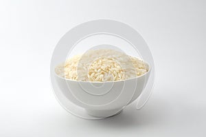 Uncooked rice, jasmine rice, mali rice,Thai jasmine rice in a white bowl ceramic on white background.
