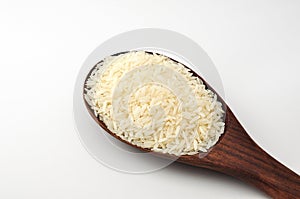 Uncooked rice, jasmine rice, mali rice,Thai jasmine rice in a wood ladle on white background.