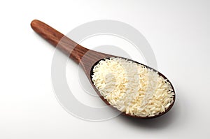 Uncooked rice, jasmine rice, mali rice,Thai jasmine rice in a wood ladle on white background