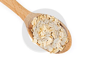 Uncooked rolled oats in wooden spoon on a white background