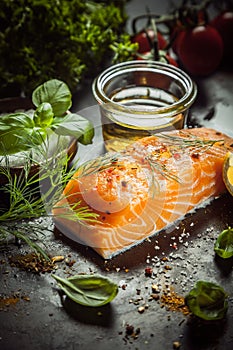 Uncooked salmon fillet with fresh herbs and spices