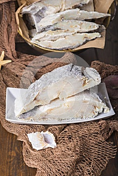 Uncooked salted cod on fishing nets