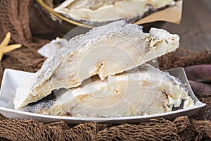 Uncooked salted cod on fishing nets