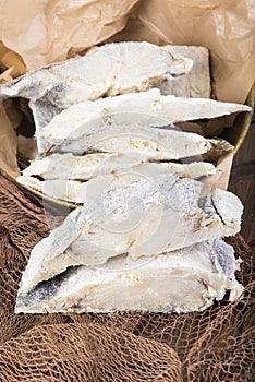 Uncooked salted cod on fishing nets