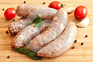 Uncooked sausages with vegetables