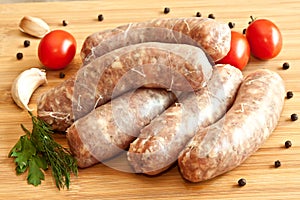 Uncooked sausages with vegetables