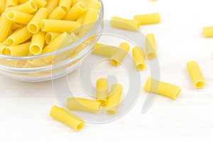 Uncooked short pasta tubes, elicoidali in a glass bowl