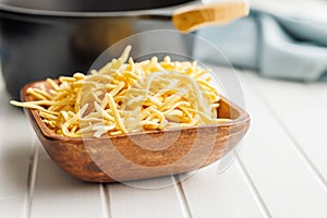 Uncooked spaetzle pasta in bowl on kitchen table