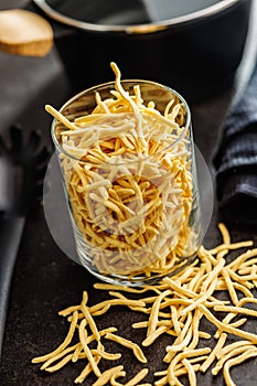 Uncooked spaetzle pasta in jar on kitchen table