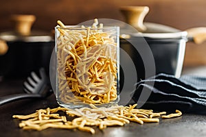 Uncooked spaetzle pasta in jar on kitchen table