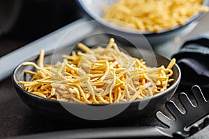 Uncooked spaetzle pasta on plate on kitchen table