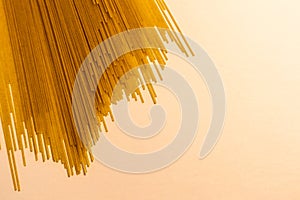 Uncooked Spaghettini Noodles Spread Out on White