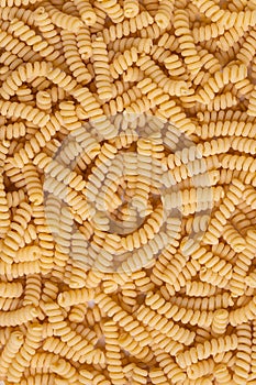 Uncooked Spiral Pasta, top view. Copy-space