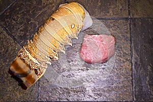 Uncooked surf and turf on slate tabletop