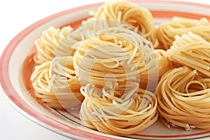 Uncooked tagliolini pasta nests