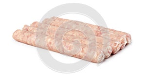 Uncooked thin long pork sausages with herbs for grilling in natural casing isolated