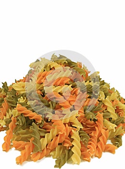 Uncooked Three-color Fusilli Pasta Piled-up on White Background, Vertical Front View Photo with Free Space for Text