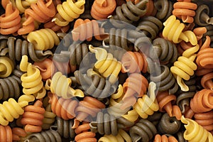 Uncooked Trottole tricolore pasta close up full frame photo