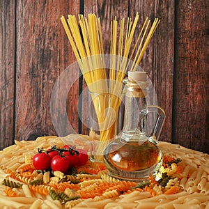Uncooked Various types of pasta, Raw pasta set and tomato, set, top view