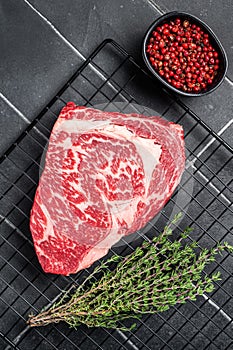 Uncooked wagyu Rib Eye steak, raw beef meat. Black background. Top view