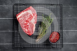 Uncooked wagyu Rib Eye steak, raw beef meat. Black background. Top view