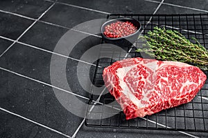 Uncooked wagyu Rib Eye steak, raw beef meat. Black background. Top view. Copy space