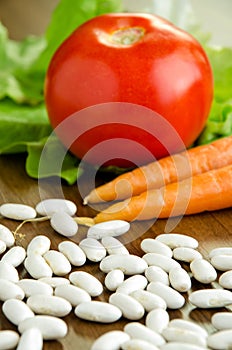 Uncooked white beans and fresh vegetables