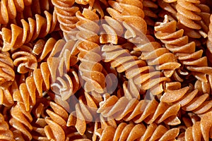 Uncooked Whole Grain Fusilli Pasta Background