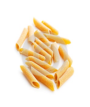 Uncooked whole grain pasta isolated on white background. Raw penne pasta