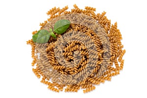 Uncooked wholemeal pasta isolated white background.