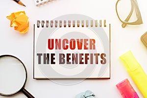 Uncover the benefits text written on office desk