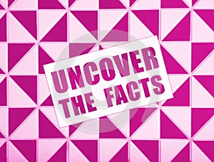 Uncover the Facts card on wooden background. Social concept. Business concept