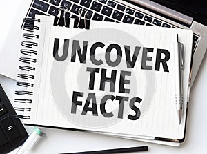 uncover the facts on notebook with laptop and calculator