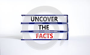 Uncover the facts symbol. Concept words Uncover the facts on books on a beautiful white table white background. Business and