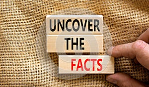 Uncover the facts symbol. Concept words Uncover the facts on wooden blocks on a beautiful canvas table canvas background.