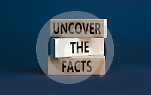 Uncover the facts symbol. Concept words Uncover the facts on wooden blocks on a beautiful grey table grey background. Business and