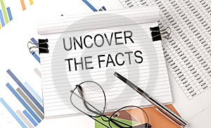 UNCOVER THE FACTS text on the chart , office supplies, business concept