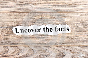 Uncover The Facts text on paper. Word Uncover The Facts on torn paper. Concept Image