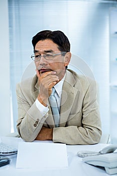 Undecided businessman at his computer