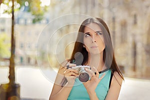Undecided Girl with Compact Digital Camera