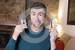 Undecided man holding shaving tools