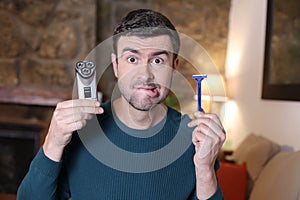 Undecided man holding shaving tools