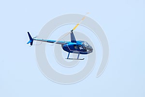 Undefined helicopter with passengers in blue sky